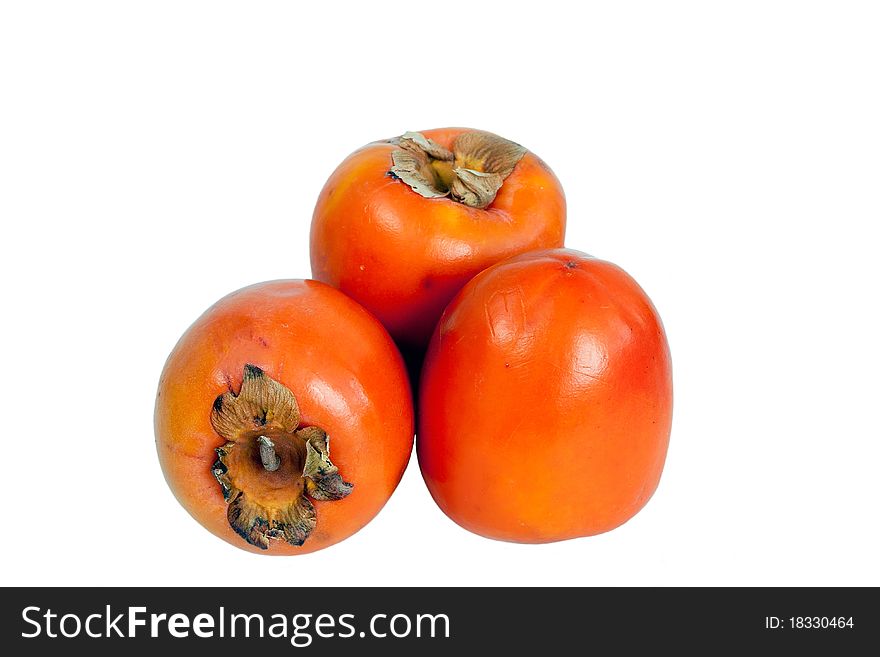 Three fresh ripe persimmons over white background