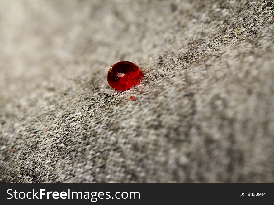 Red blood drop on whool texture