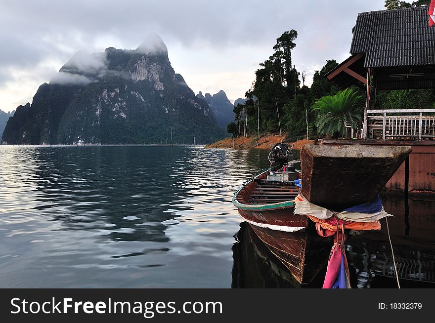 Long tailed boat floating on lake