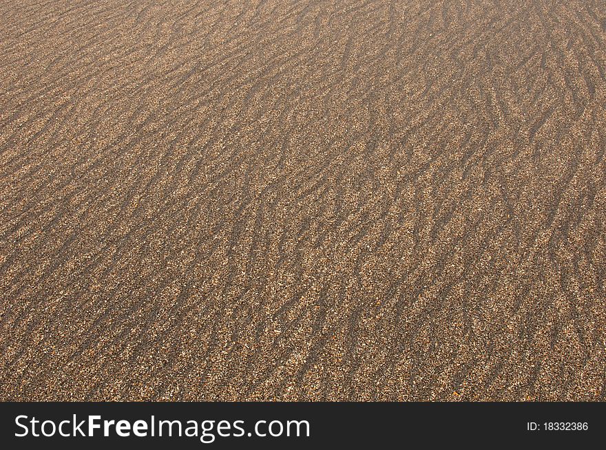 An abstract background of sand along the beach drawn by wave. An abstract background of sand along the beach drawn by wave.