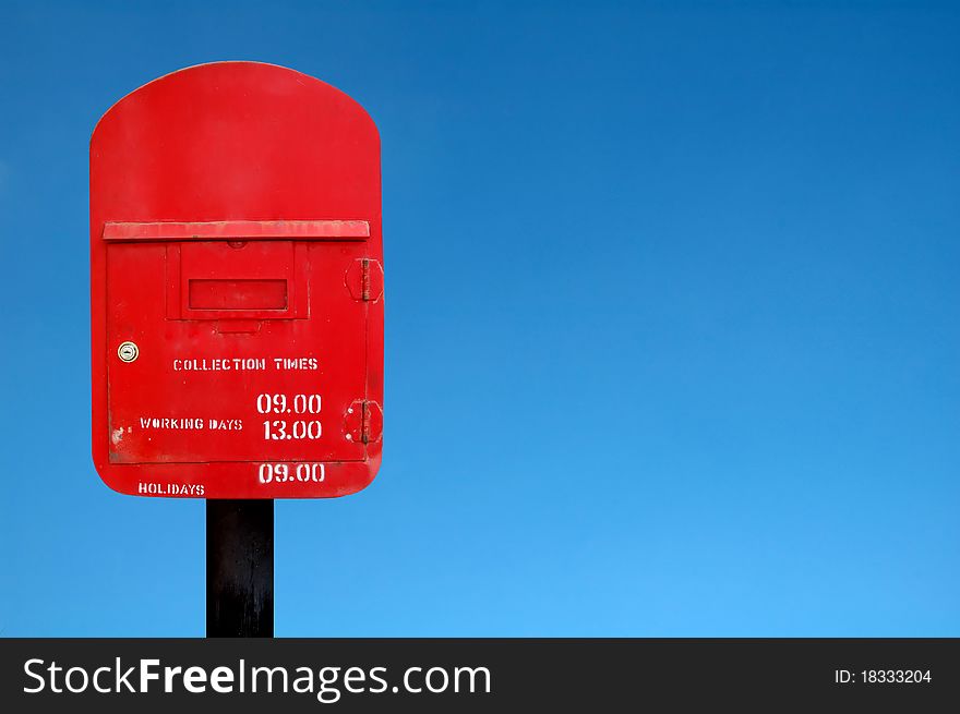 Red postbox and blue sky