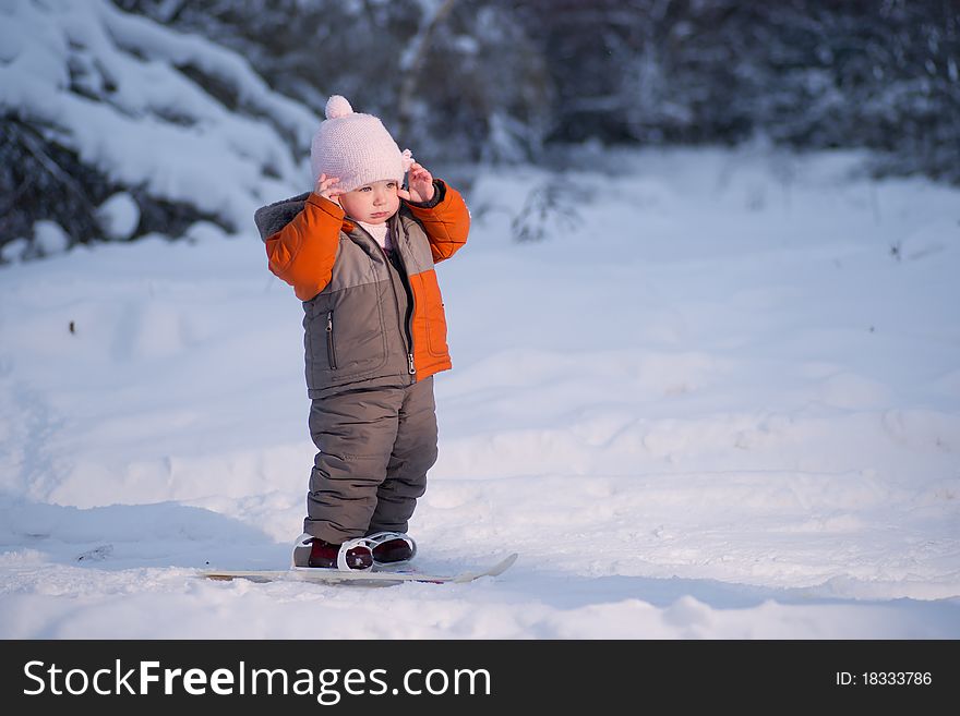 Adorable baby walk on ski in park