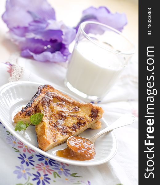 French toasts with apple jam and glass of milk for breakfast