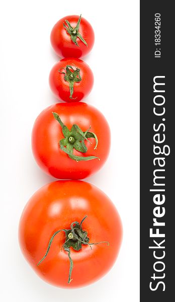 Tomato line up of four different varieties isolated on white. Tomato line up of four different varieties isolated on white.