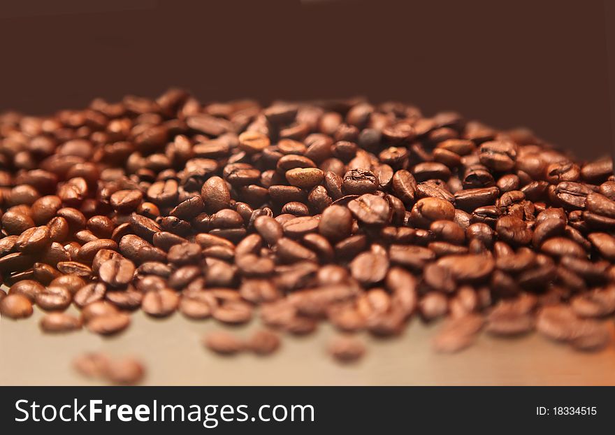 Closeup of coffee beans with focus on one. Closeup of coffee beans with focus on one