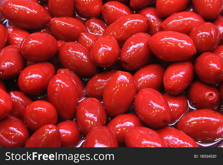 Red olives close up in sharp marinade