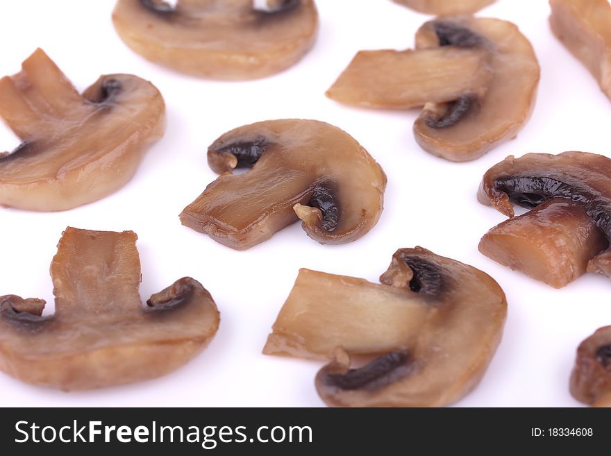 Close-up of fried brown mushrooms (champignons) isolated on white background. Close-up of fried brown mushrooms (champignons) isolated on white background
