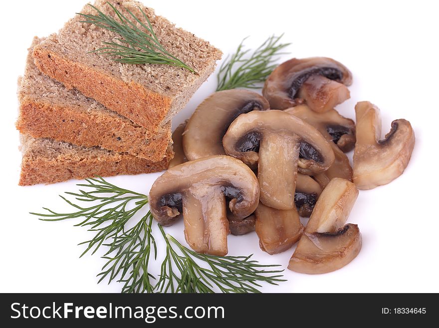 Fried mushrooms (champignons) and rye bread garnished with dill isolated on white background. Fried mushrooms (champignons) and rye bread garnished with dill isolated on white background