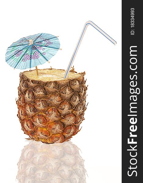 Half of a pineapple is a cocktail with a tube and umbrella. Half of a pineapple is a cocktail with a tube and umbrella.