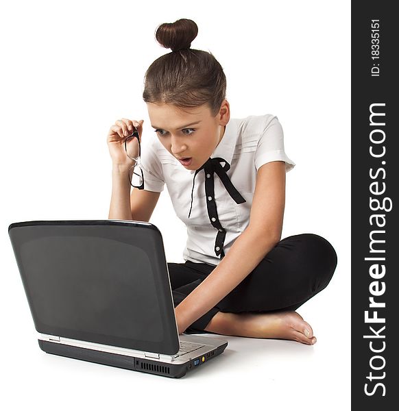 Beautiful girl sitting on the floor and works on a laptop keep the glasses in her hand isolated on white background Student Series