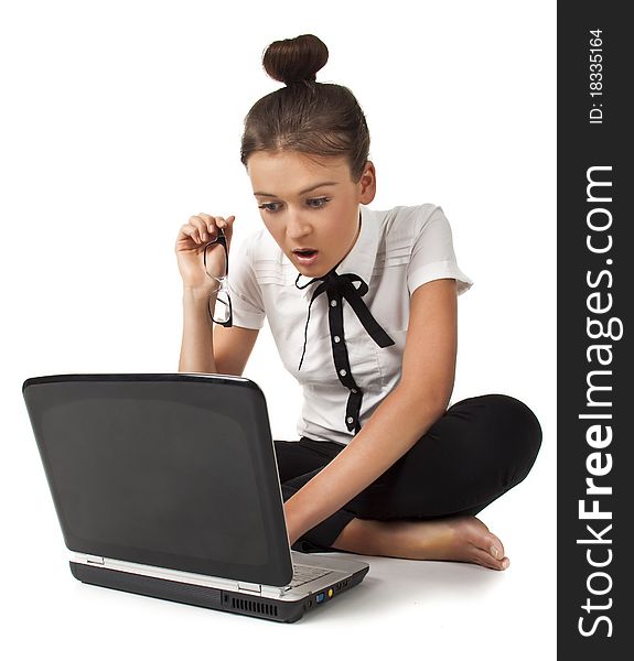 Girl sitting on the floor and works on a laptop