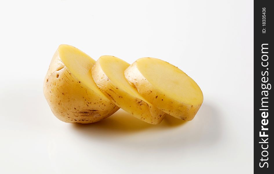 Studio shot of a sliced raw potato. Studio shot of a sliced raw potato