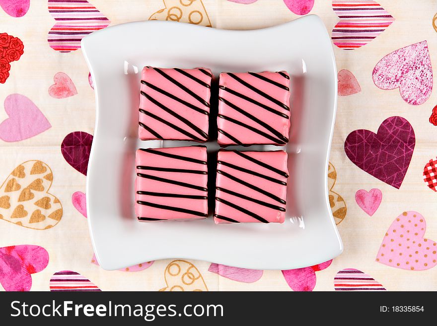 Pink cakes on white ceramic plate