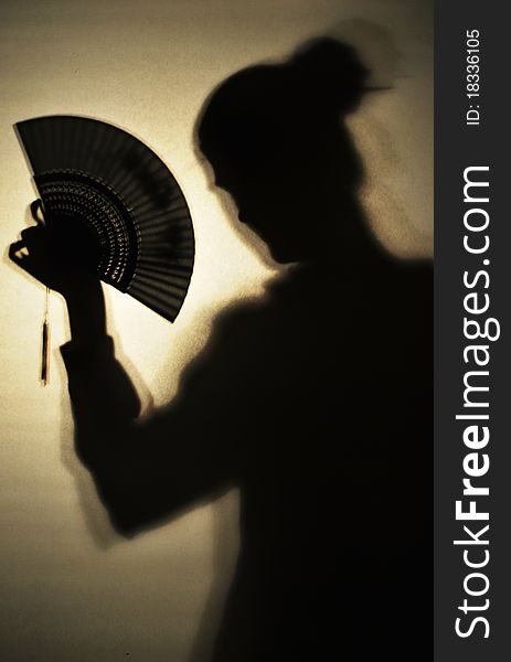 Shadow of a girl holding chinese fan. Shadow of a girl holding chinese fan