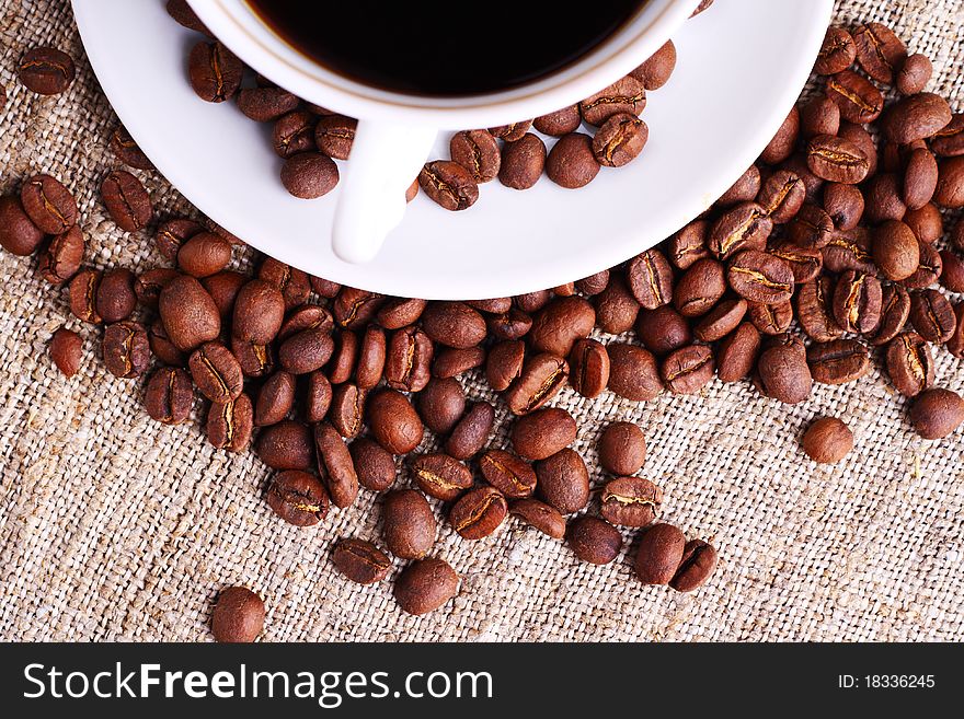 Coffee cup and grain on a fabric. Still-life