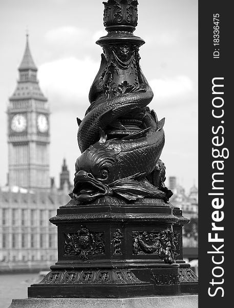 An ornate fish carved lamp post sits in the foreground while Big Ben stands tall in the distance. An ornate fish carved lamp post sits in the foreground while Big Ben stands tall in the distance.