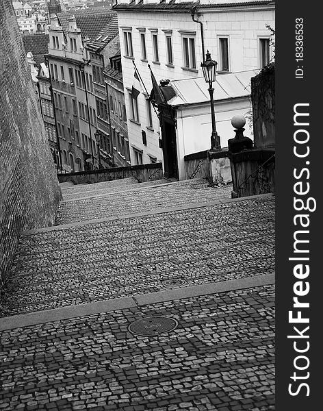 Cobblestone stair case beside brick city wall into Prague's old town. Cobblestone stair case beside brick city wall into Prague's old town