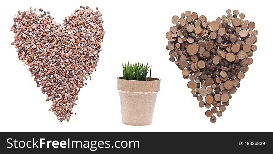 Environment Concept with Hearts of Rock and Tree and a Pot with Green Grass Growing Isolated on White. Environment Concept with Hearts of Rock and Tree and a Pot with Green Grass Growing Isolated on White.