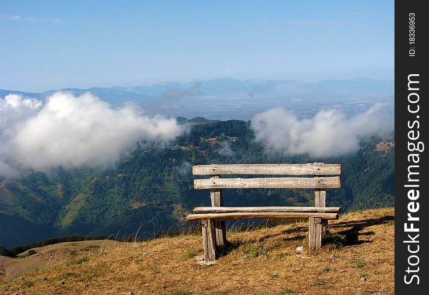 A bench in the mountains above the clouds. A bench in the mountains above the clouds