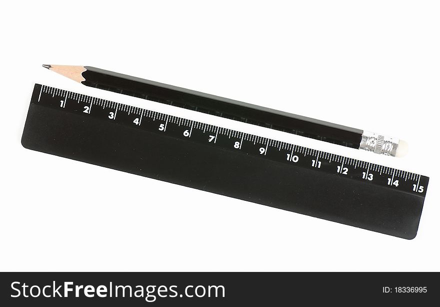 Black ruler and pencil isolated on the white. Black ruler and pencil isolated on the white