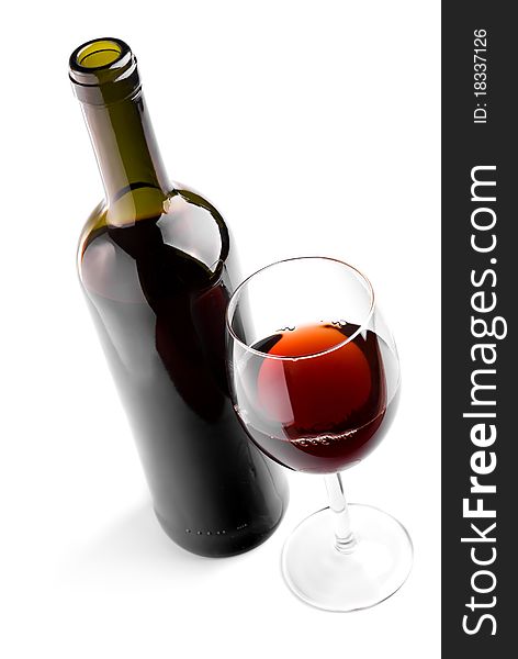 Glass and bottle with red wine on white