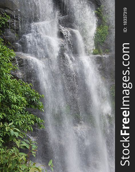 Waterfall cascading over rocks of a cliff in Thailand. Waterfall cascading over rocks of a cliff in Thailand.