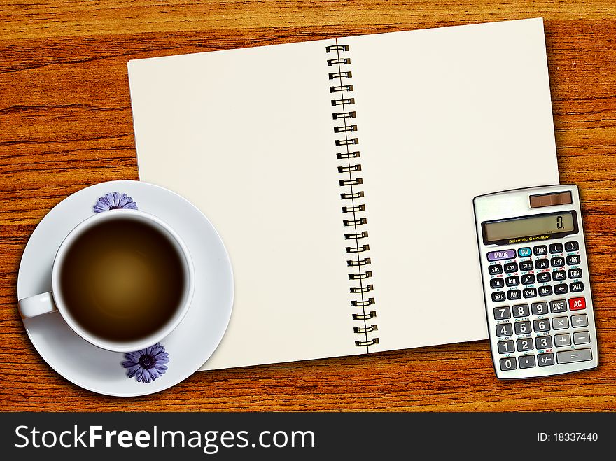 White cup of coffee and calculator on blank page notebook on wood table background