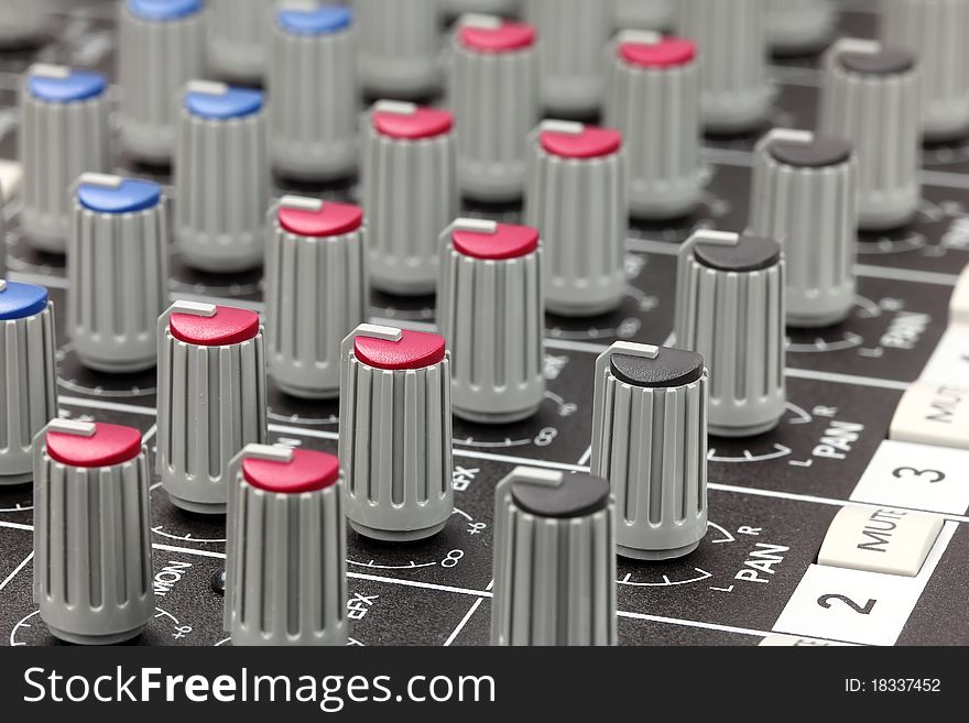 Closeup of audio mixing console. Shallow depth of field.