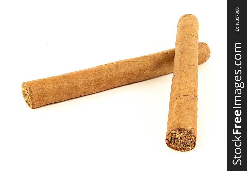 Two hand rolled cuban cigars on white background. Two hand rolled cuban cigars on white background