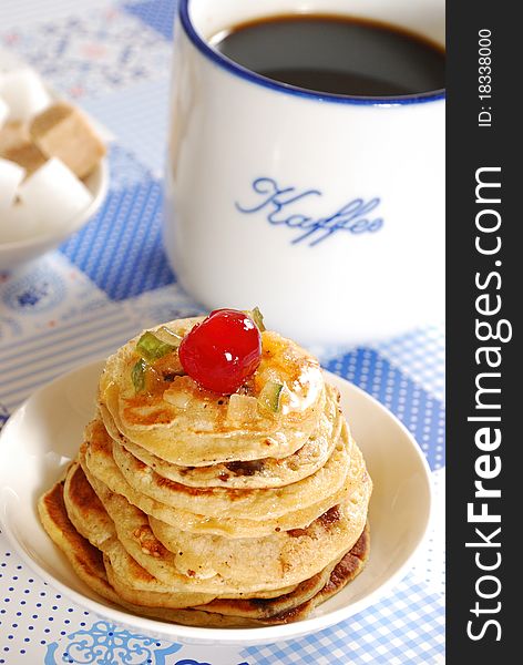 Pancakes with cup of coffee on a table. Pancakes with cup of coffee on a table