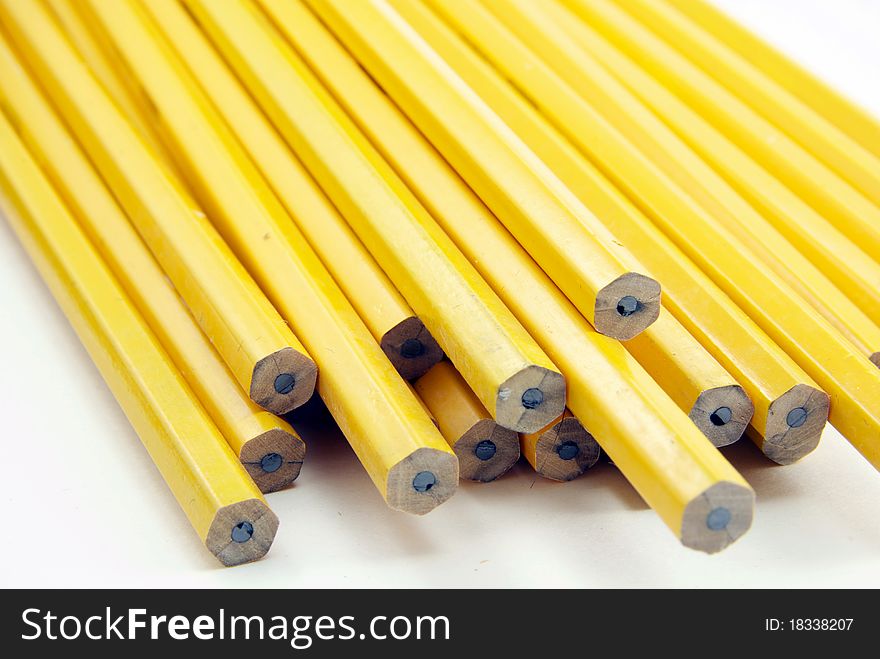 Yellow pencils arranged against a white background.