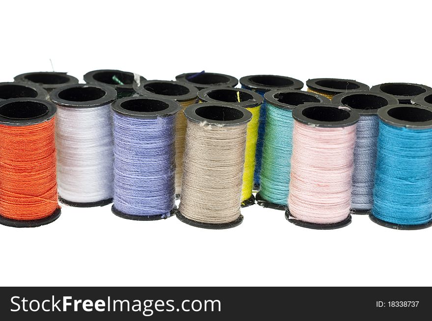 Spools of Thread Background with Many Colors on White.