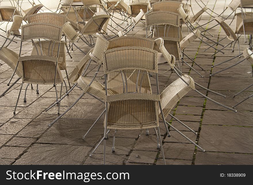 Cafe chairs folded up late at night