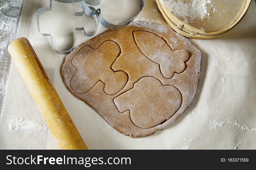 Gingerbread Dough Is Rolled On The Table. Figures Are Cut Out Of It With Moulds. The Table Is Suppaned With Flour