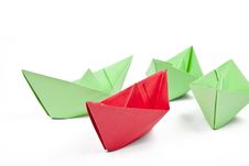 Single Red Paper Boat Between Lots Of Green Paper Royalty Free Stock Photography Single Red Paper Boat Between Lots Of Green Paper Royalty Free Stock Photography