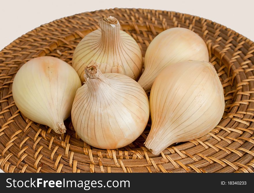 Ripe Onions On A Wicker Plate