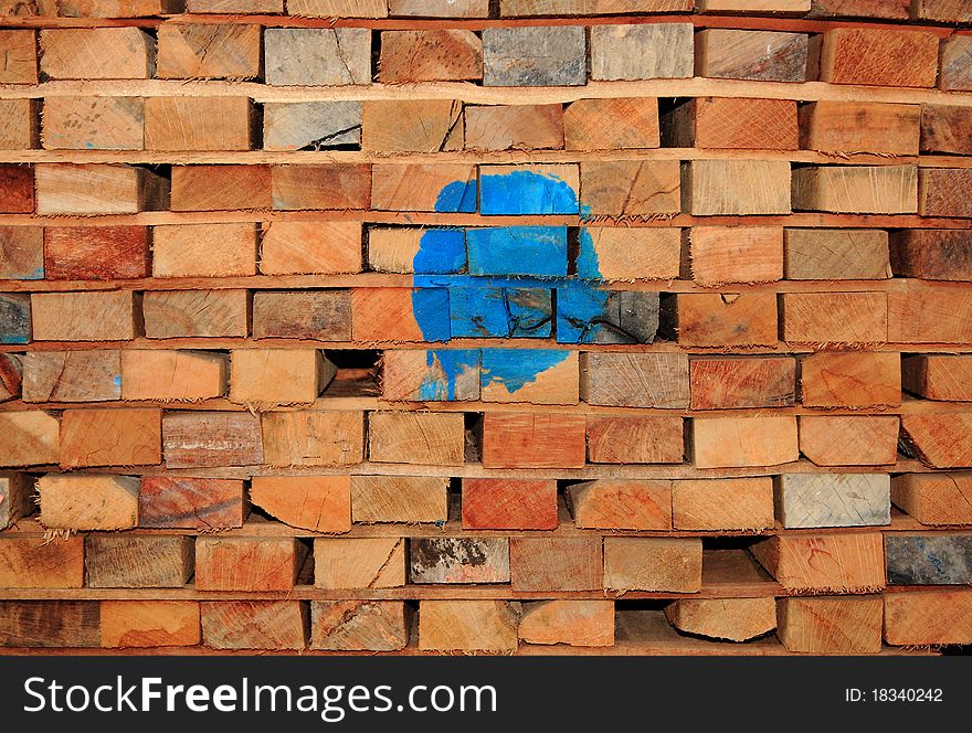 Stacked pile of wooden timber.