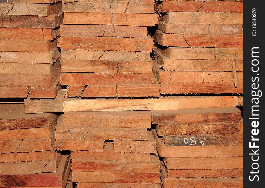 Stacked pile of wooden timber. Stacked pile of wooden timber.