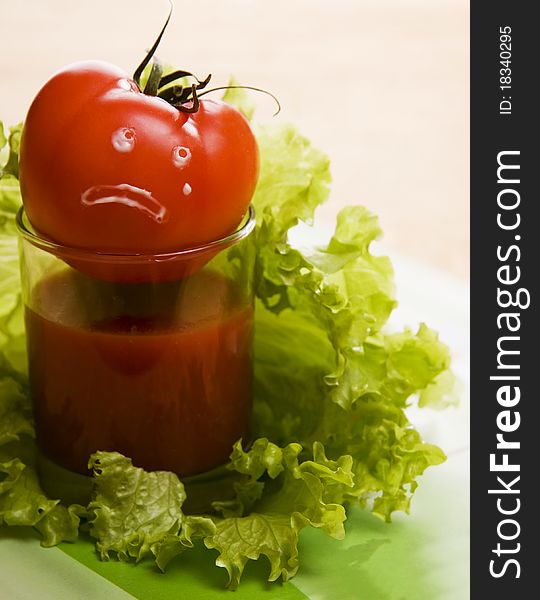Red tomato on glass with leaf lettuce. When tomatos cry. Red tomato on glass with leaf lettuce. When tomatos cry...