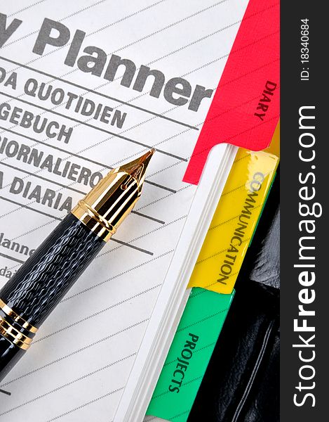 Note book including diary plan and a fountain pen, shown as daily woking plan and information. Note book including diary plan and a fountain pen, shown as daily woking plan and information.