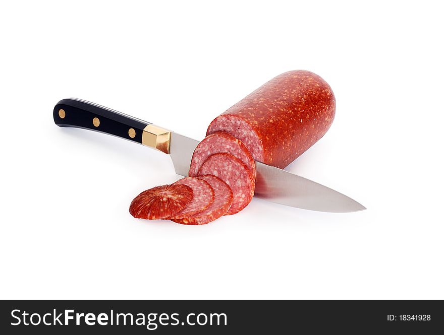 Sliced sausage and kitchen knife isolated on white background with clipping path. Sliced sausage and kitchen knife isolated on white background with clipping path