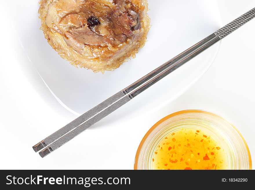 Chinese glutinous rice or known as 'loh mai kai' served on plate with chopsticks and sauce