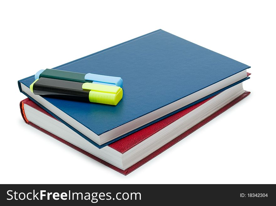Two books and two markers on a white background