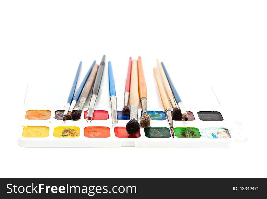 Watercolors with paint brushes isolated on a white background. Watercolors with paint brushes isolated on a white background.