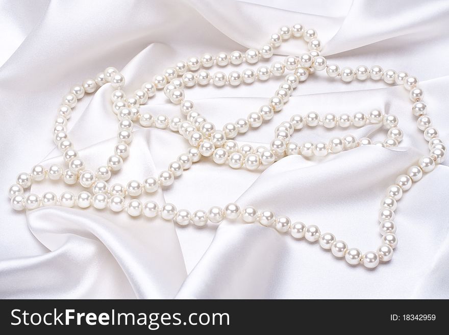 Jewels on white satin as a background