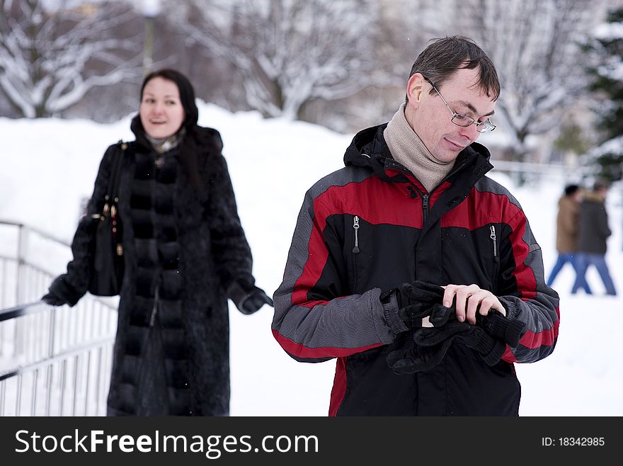 Man waiting the woman and looking watch in winter time. Man waiting the woman and looking watch in winter time