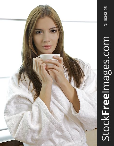 Attractive young woman in PJ's with her morning coffee