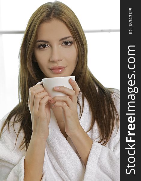 Attractive young woman in PJ's with her morning coffee