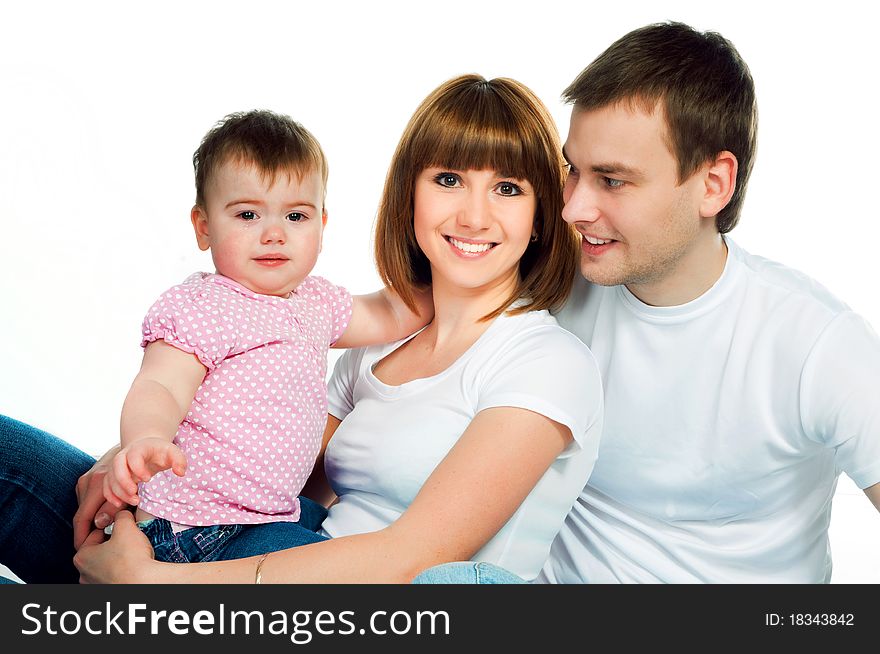 Happy family with a baby on a color background