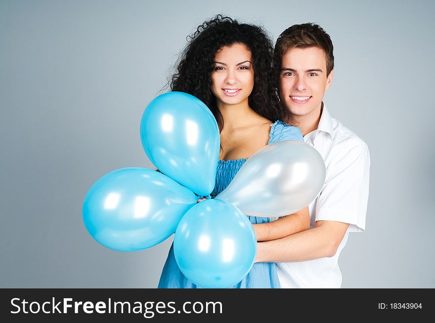 Beautiful young couple with balloons